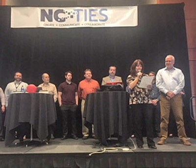 Group on stage at NC Ties awards